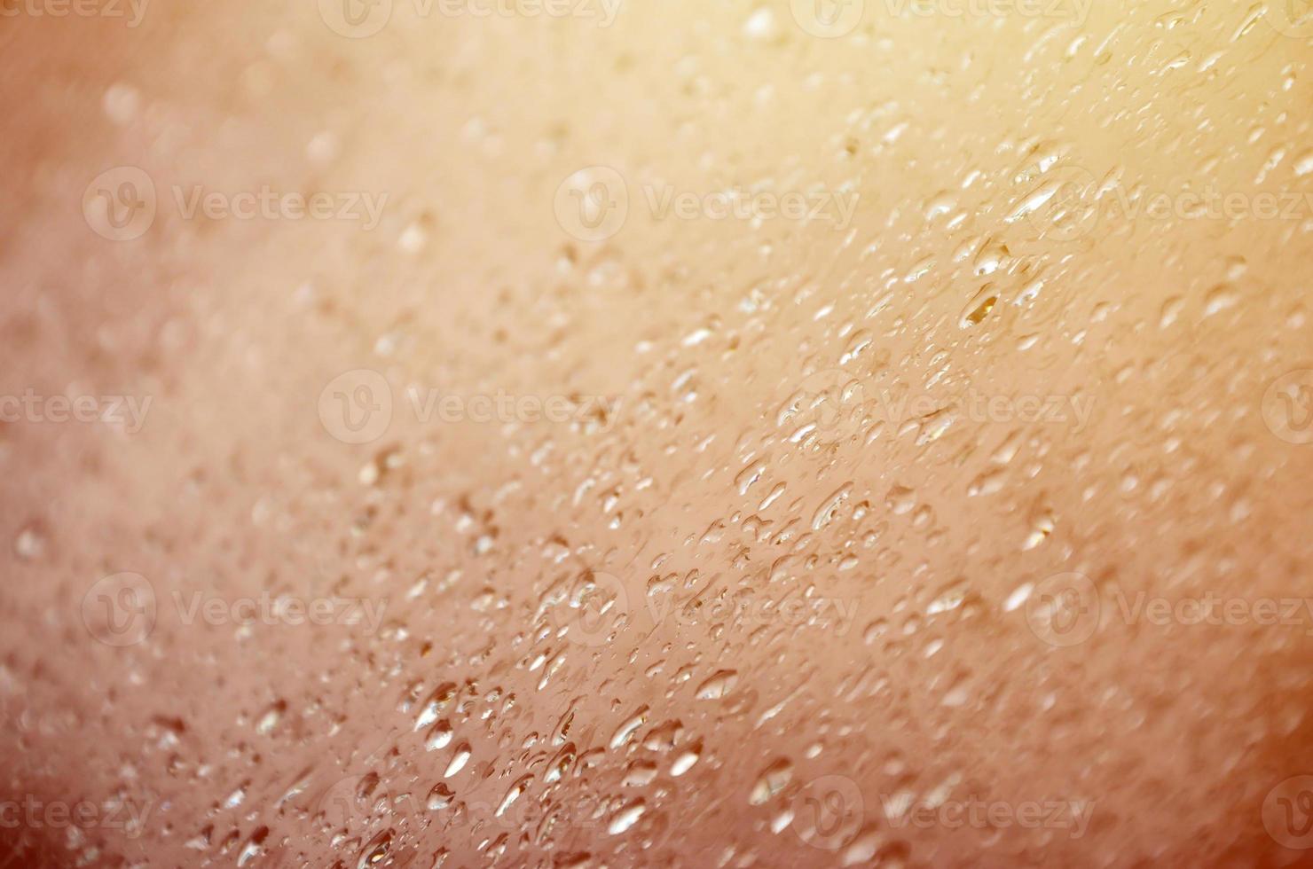 Background image of rain drops on a glass window. Macro photo with shallow depth of field. Toned picture
