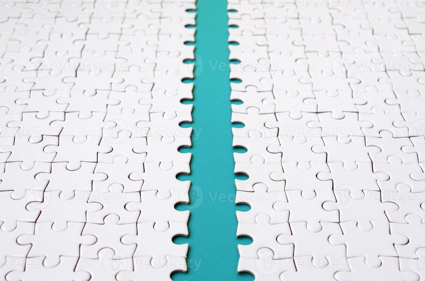 The blue path is laid on the platform of a white folded jigsaw puzzle. Texture image with copy space for text photo