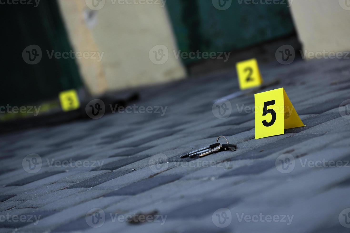 Evidence with yellow CSI marker for evidence numbering on the residental backyard in evening. Crime scene investigation concept photo