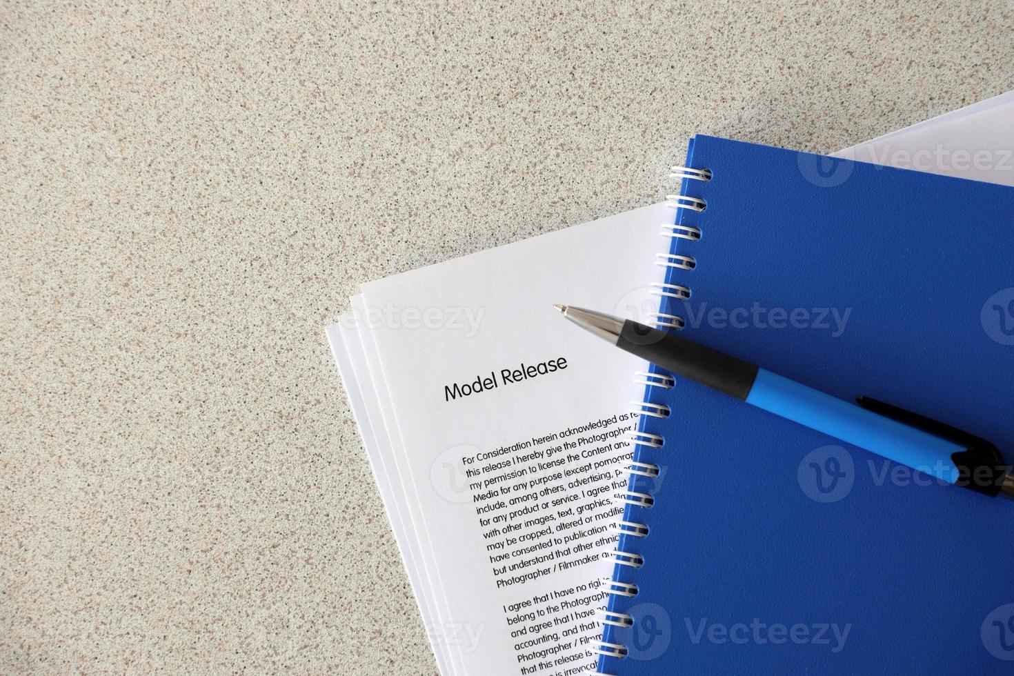 Model release blank form with blue notepad and blue pen lies on photographers table. Model release signing photo