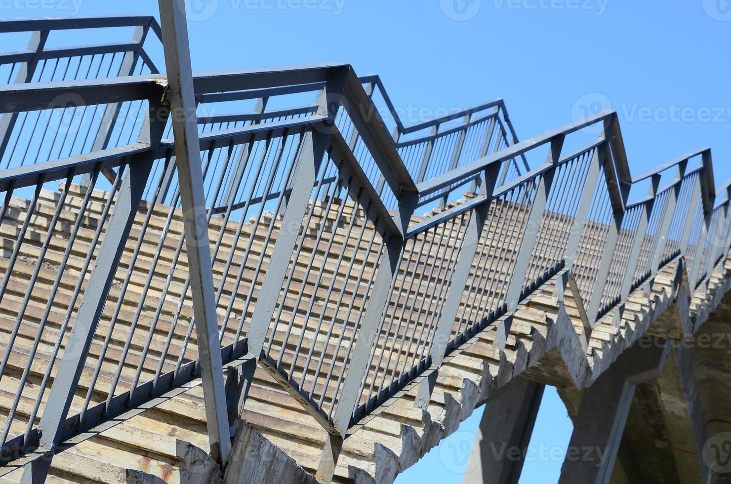 A fragment of a stepped ascent to the pedestrian bridge between the platforms of the railway station photo