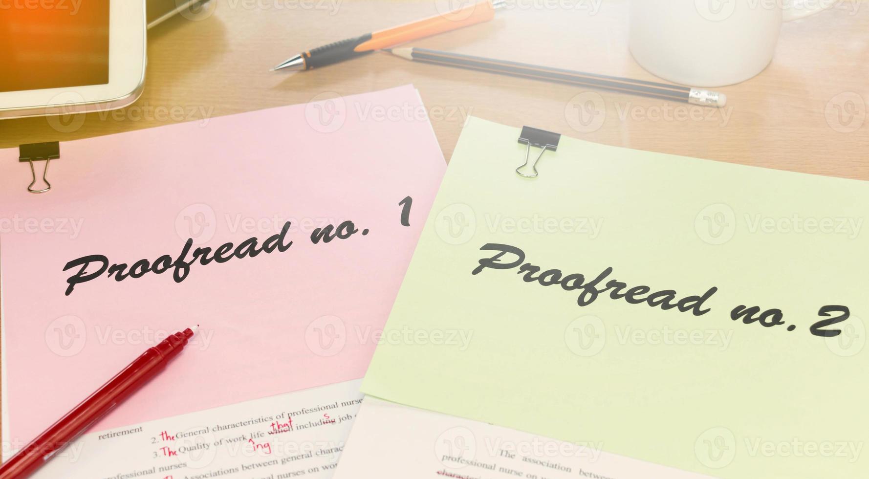 proofreading paper on table photo