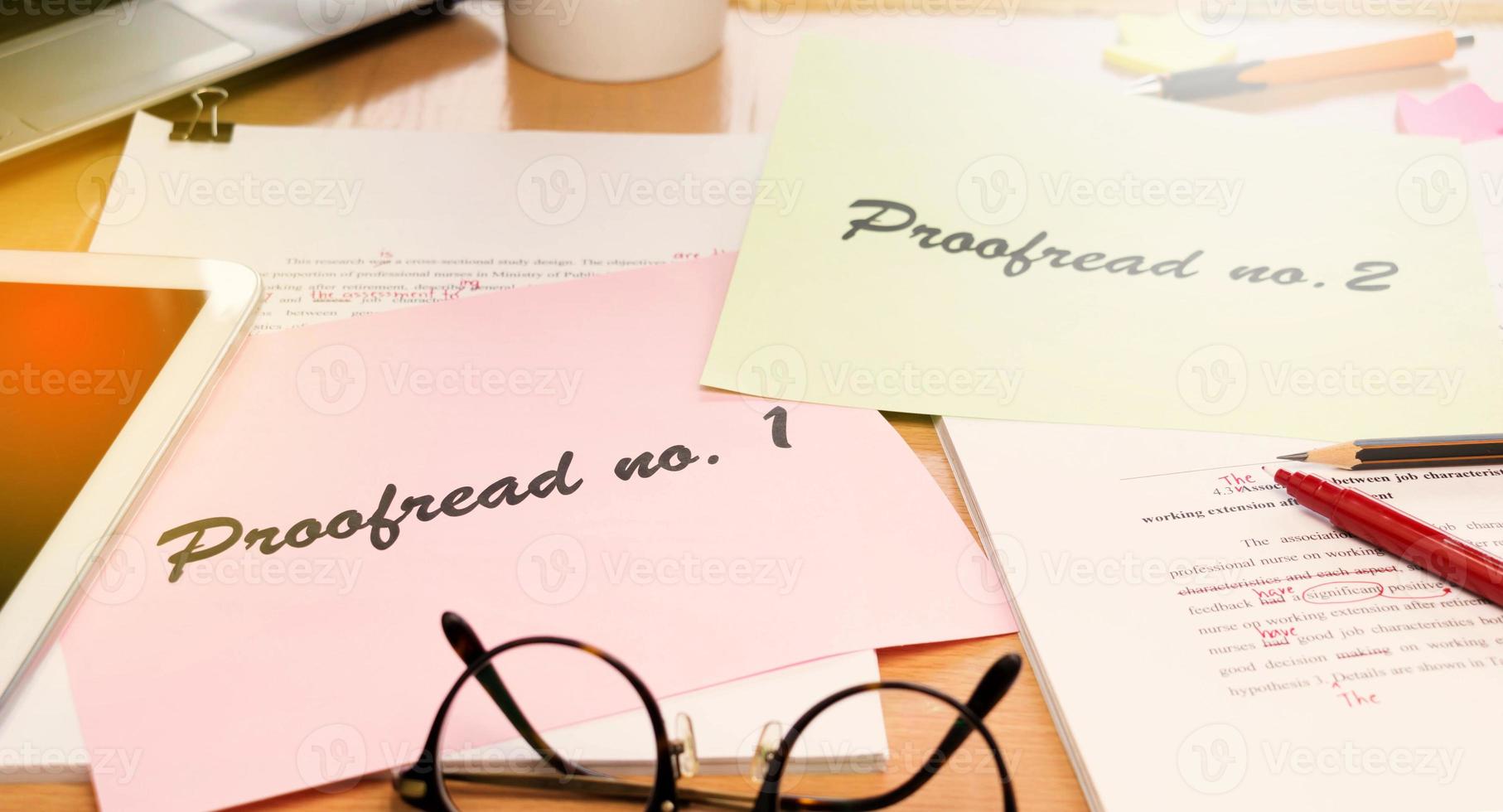proofreading paper on table photo