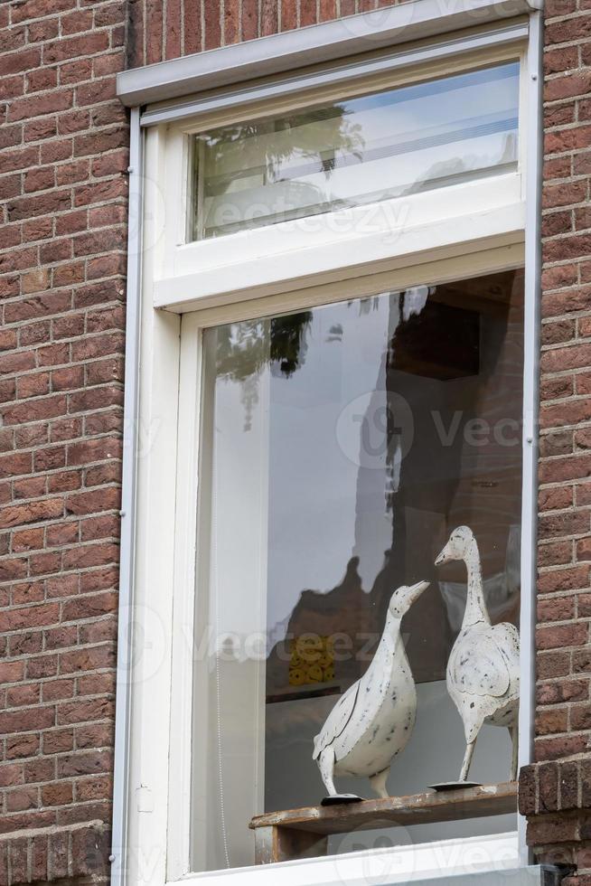 old window with wooden swan photo