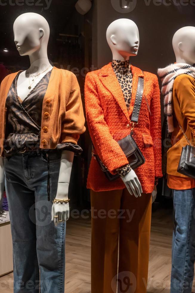 mannequins in a shop window with night lighting photo