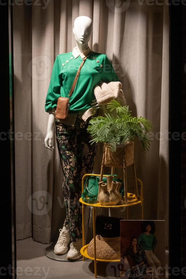 mannequins in a shop window with night lighting photo
