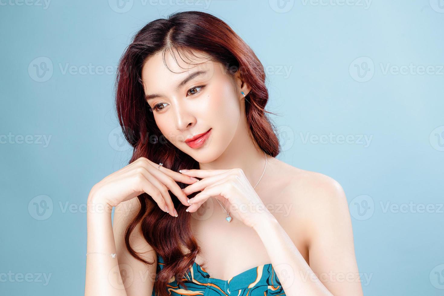 Asian woman with a beautiful face and Perfect clean fresh skin. Cute female model with natural makeup and sparkling eyes on white isolated background. Facial treatment, Cosmetology, beauty Concept. photo