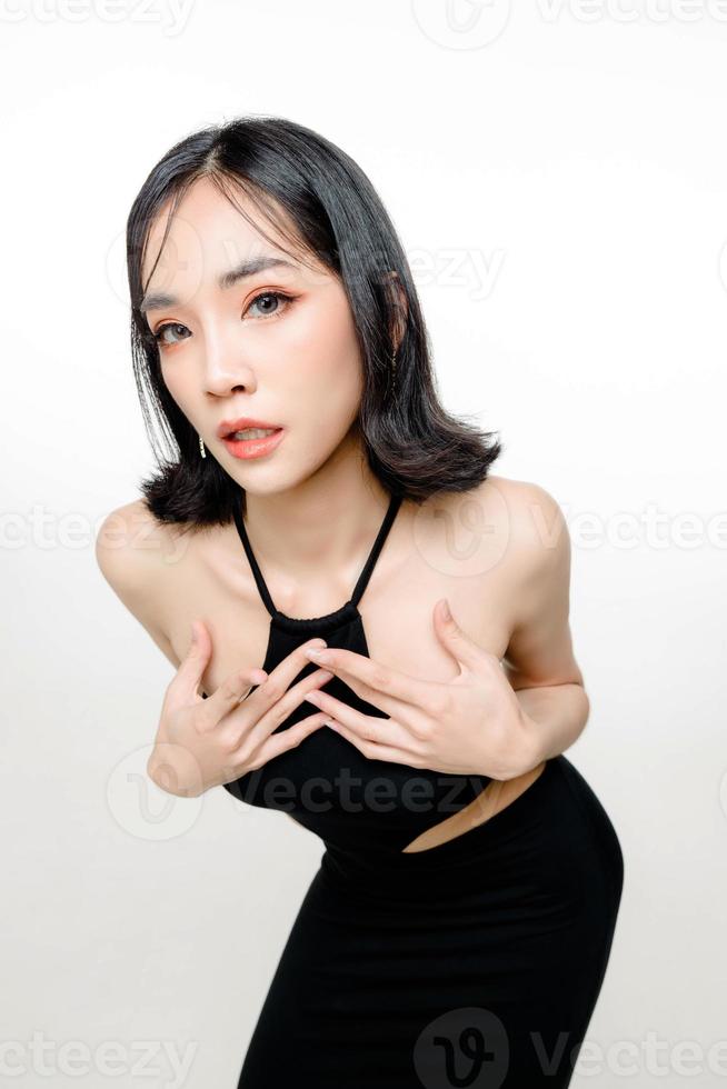 Fashionable asian woman short hair with Perfect body. Cute female model with natural makeup and sparkling eyes on white isolated background. Facial treatment, Cosmetology, beauty Concept. photo