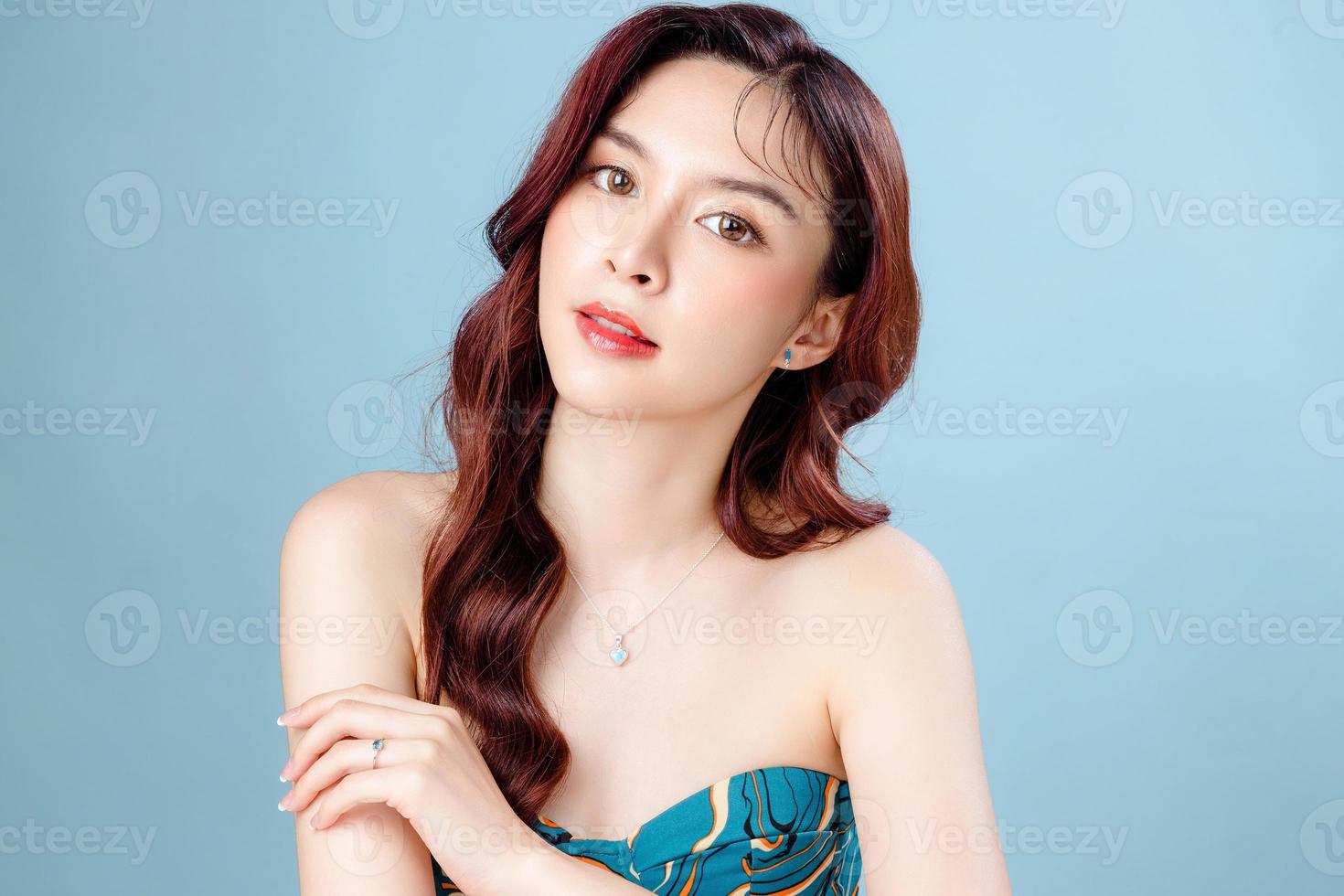 Asian woman with a beautiful face and Perfect clean fresh skin. Cute female model with natural makeup and sparkling eyes on white isolated background. Facial treatment, Cosmetology, beauty Concept. photo