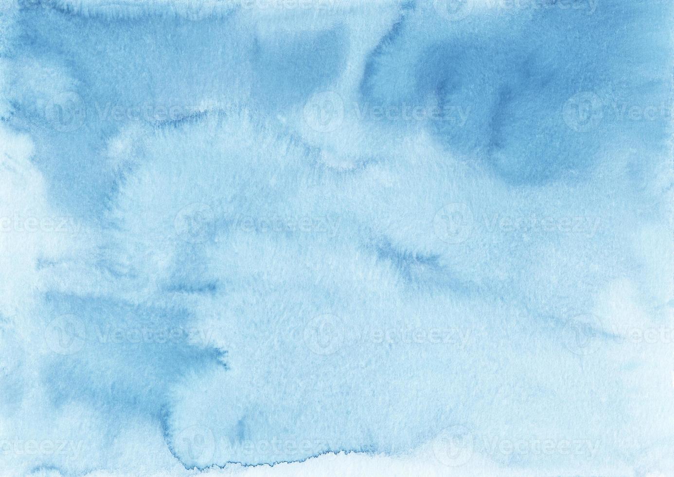 Watercolor light blue background with copy space. Azure blue stains on paper, hand painted. Liquid backdrop photo