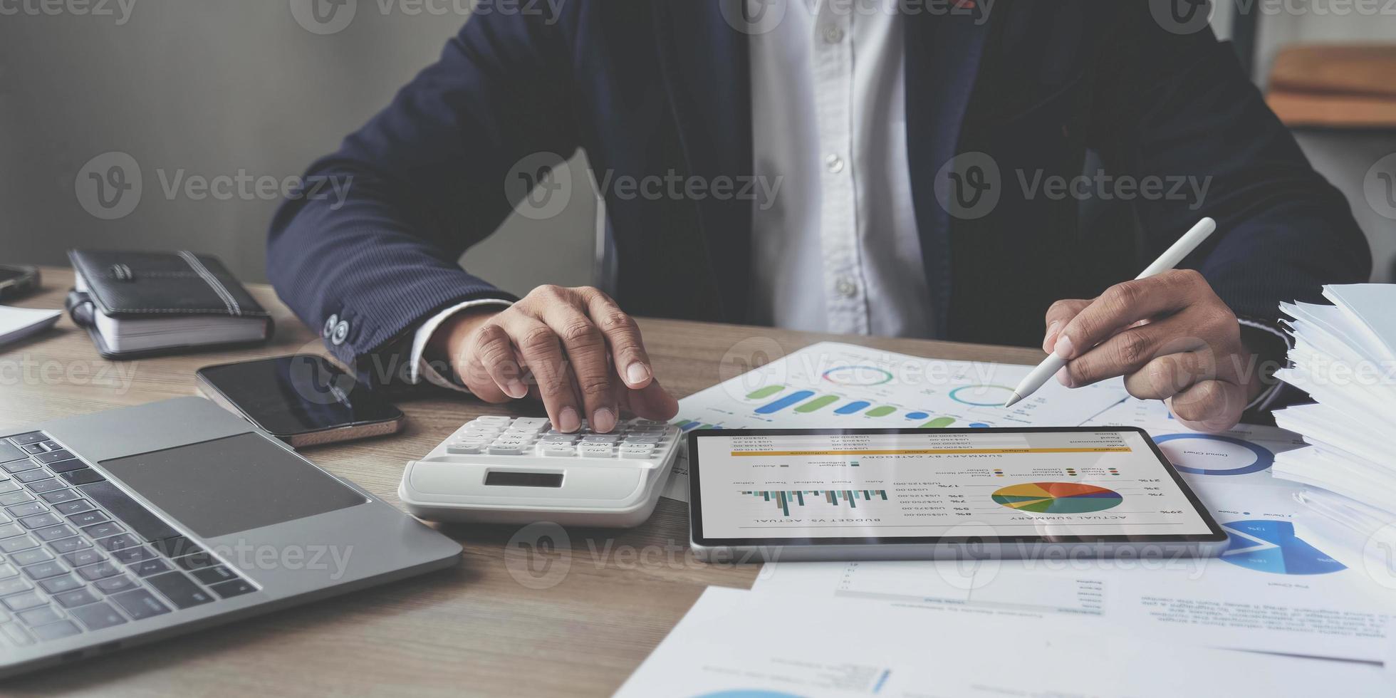 businessman writing business plan at desk in modern office. Planning analyze investment, business strategy and marketing, using graph chart and digital tablet. photo