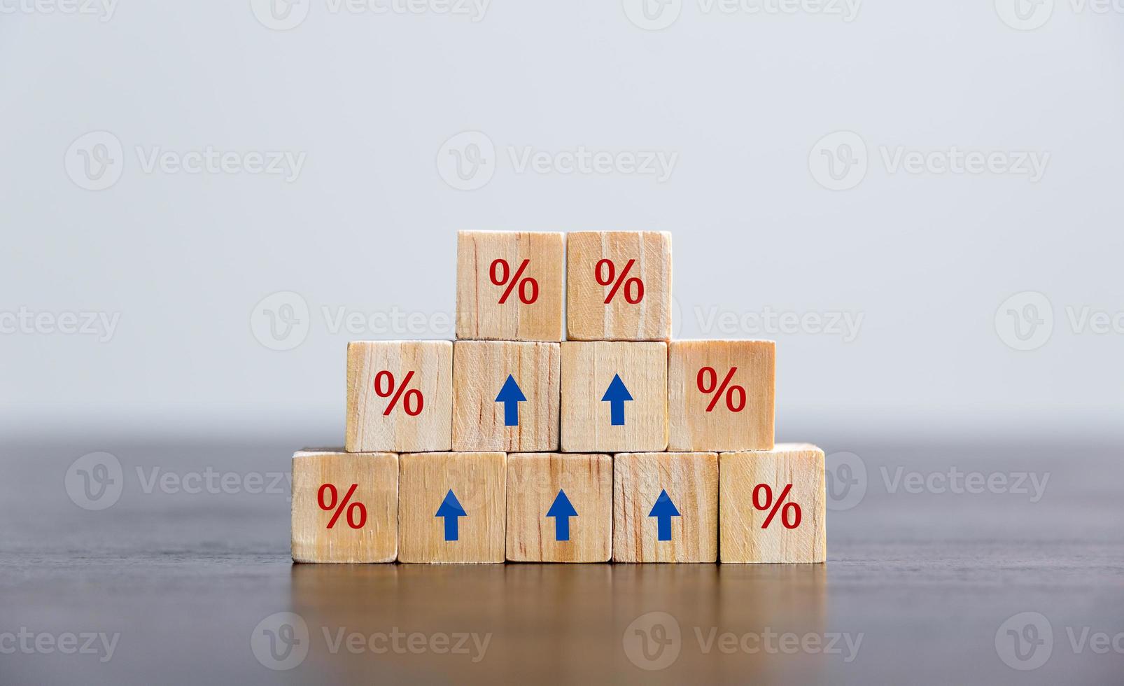 Closeup wood cubes with percentage symbol, Percent and upwards increasing arrows on wooden cubes. Financial interest mortgage rates increase or price commission raise, growth business, finance tax. photo