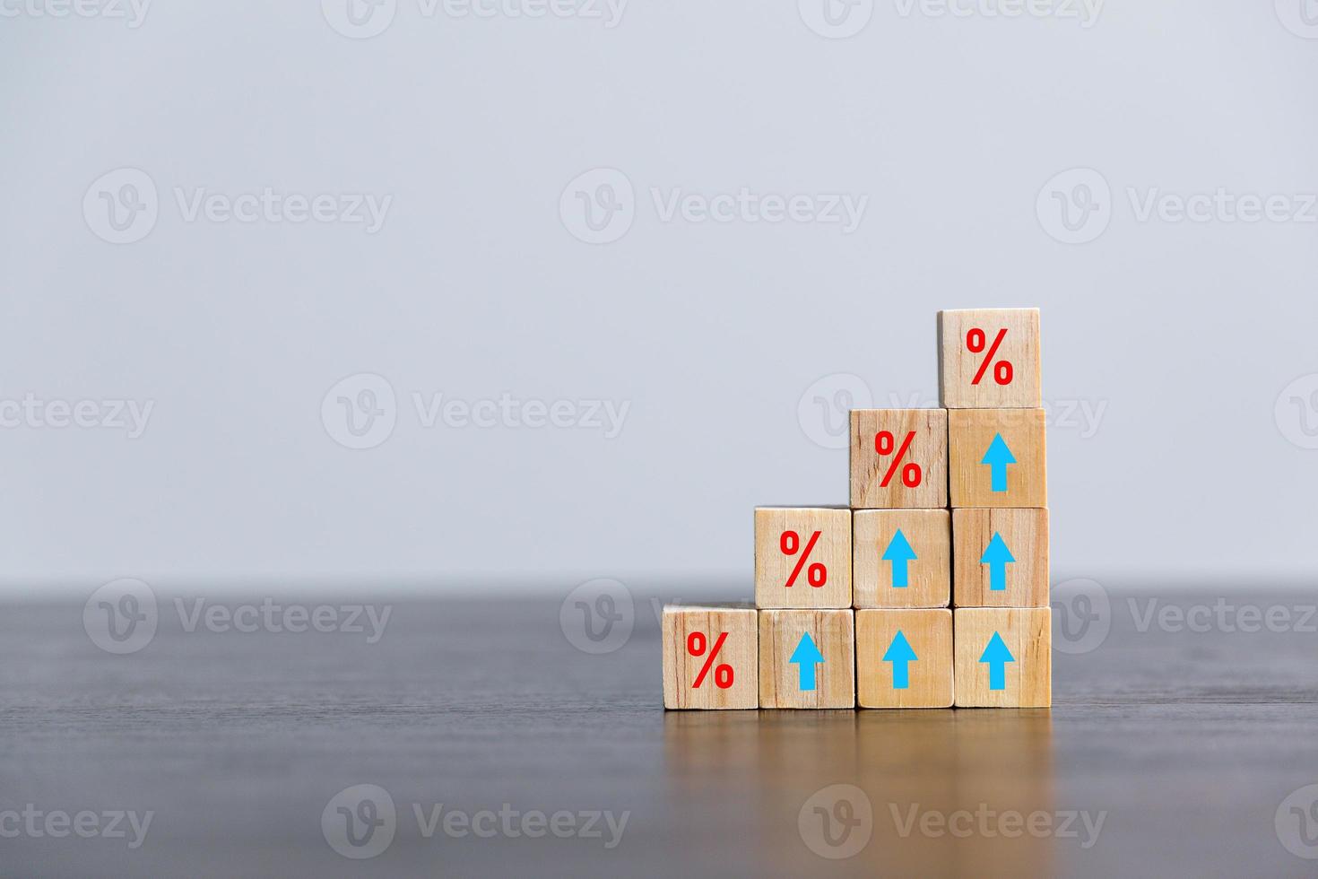 Closeup wood cubes with percentage symbol, Percent and upwards increasing arrows on wooden cubes. Financial interest mortgage rates increase or price commission raise, growth business, finance tax. photo