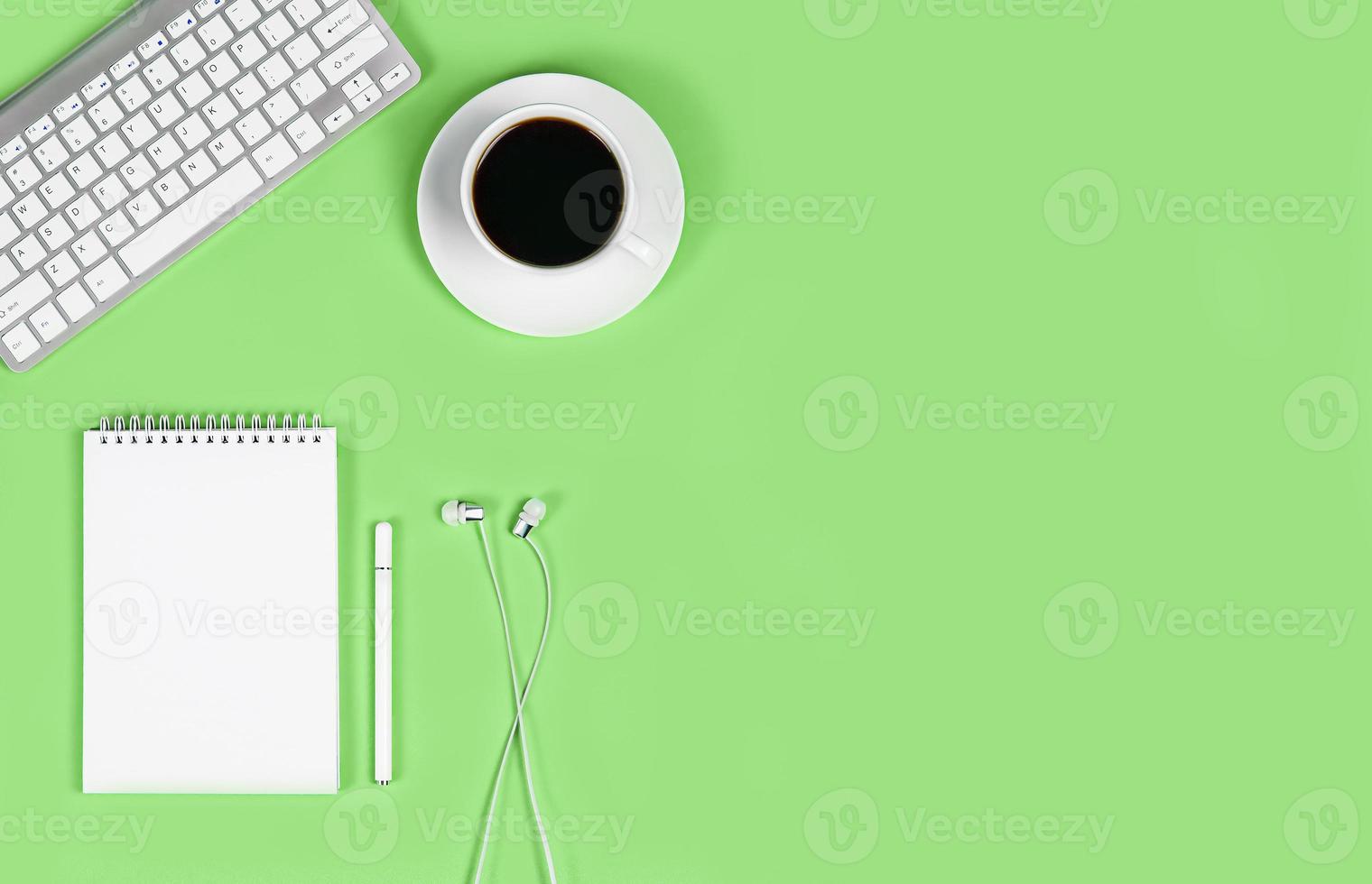 Flat lay on green background. online conference, desktop, work from home and learning, blogging, online education photo