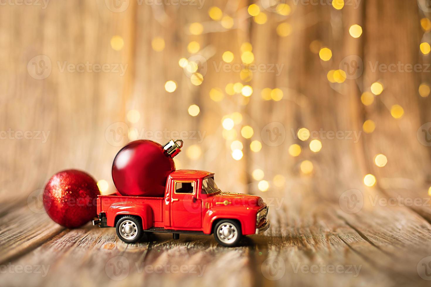 miniature car on wooden background with christmas light. photo