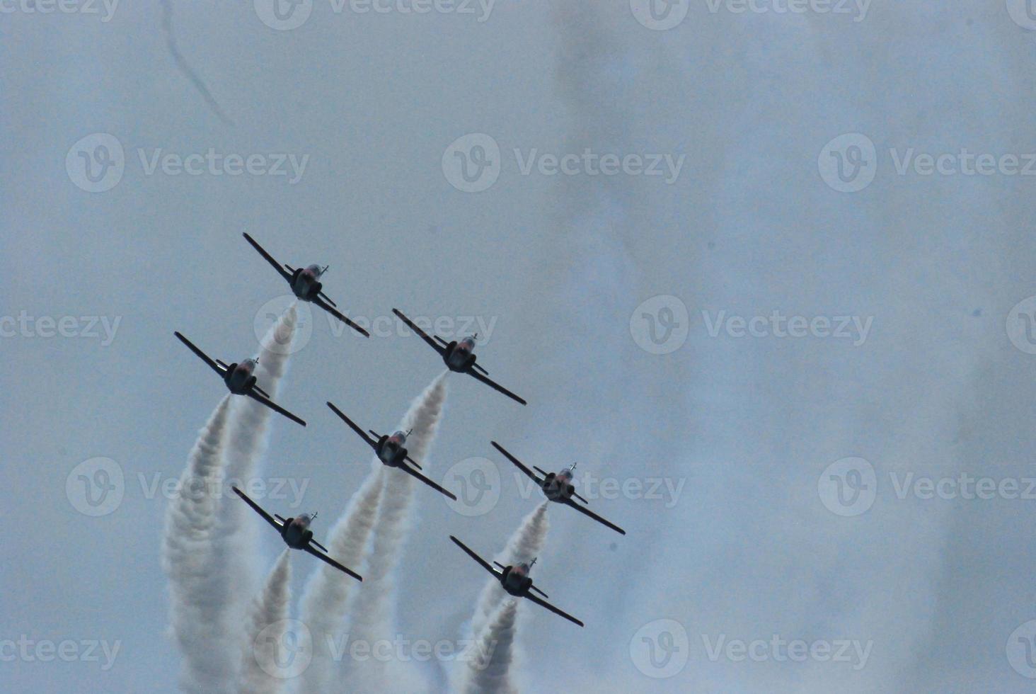 jet planes flying in formation at an exhibition photo