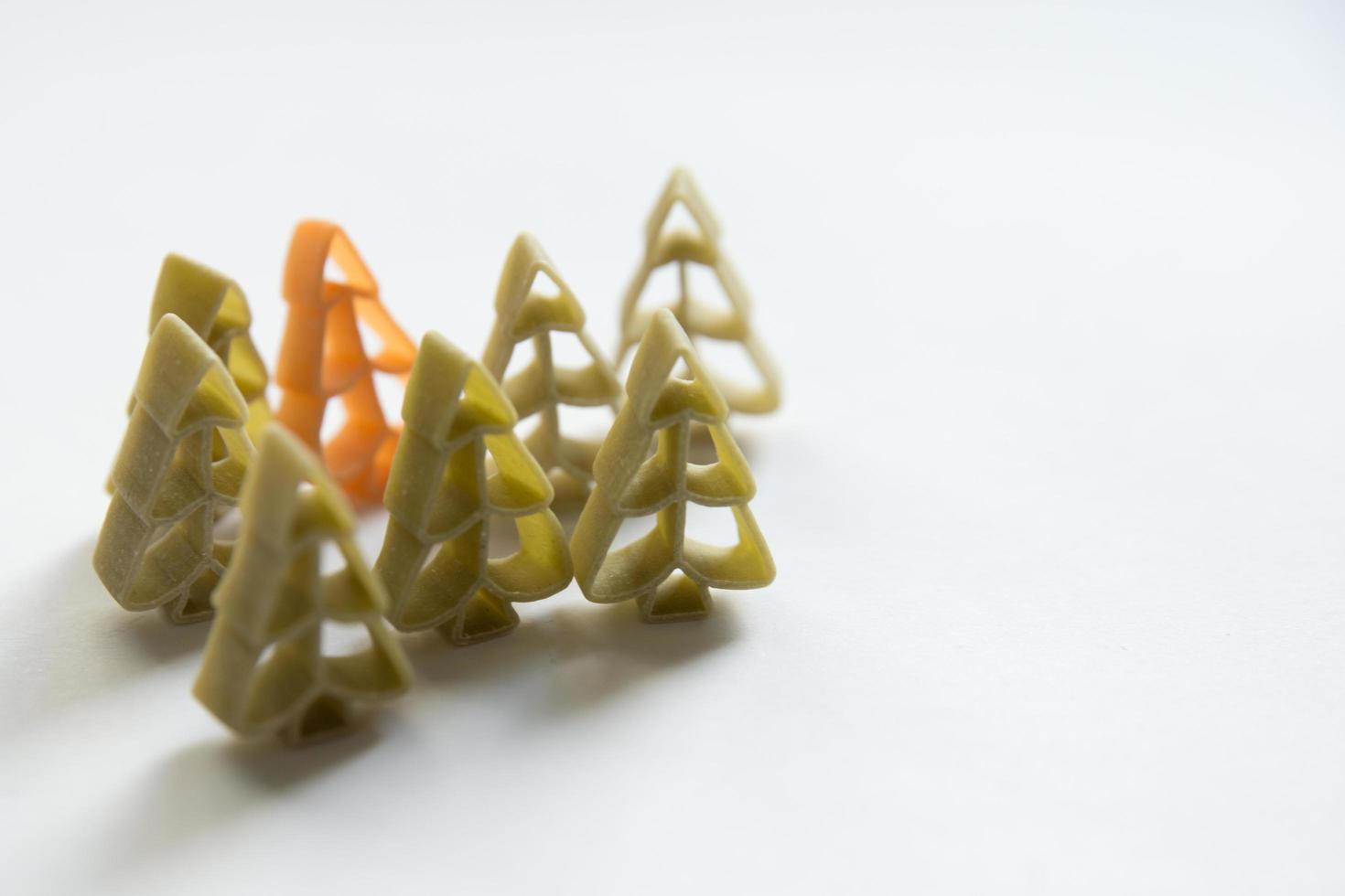 Christmas pattern. Green and orange tree shaped pasta photo