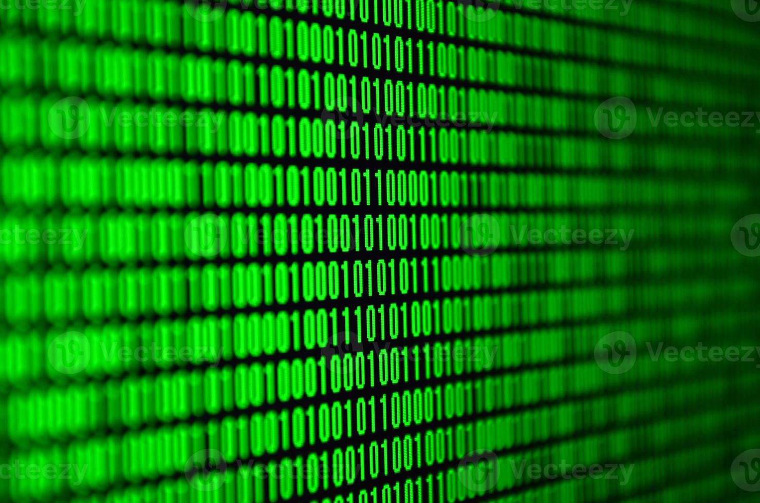 An image of a binary code made up of a set of green digits on a black background photo