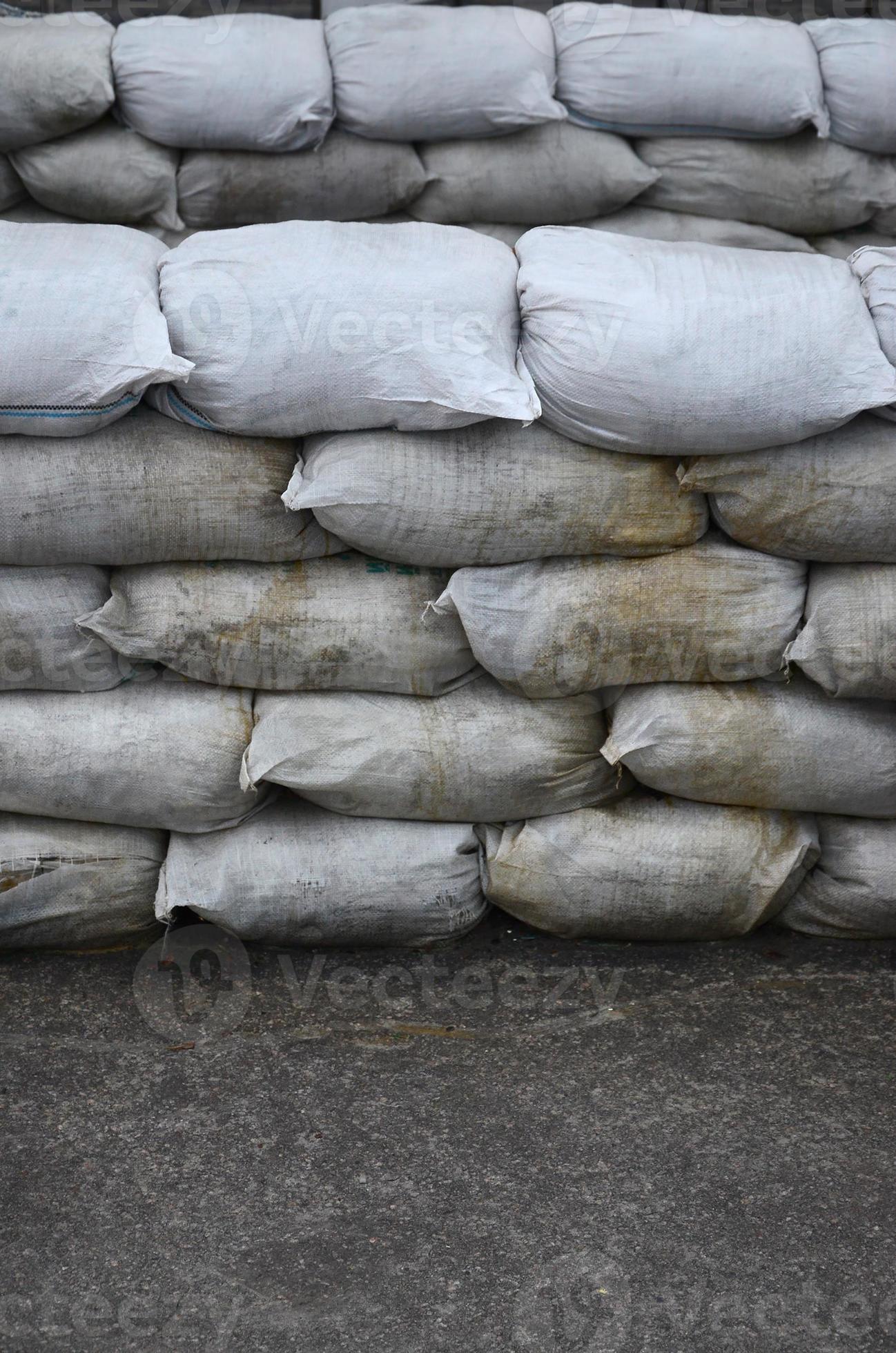 Background of many dirty sand bags for flood defense. Protective