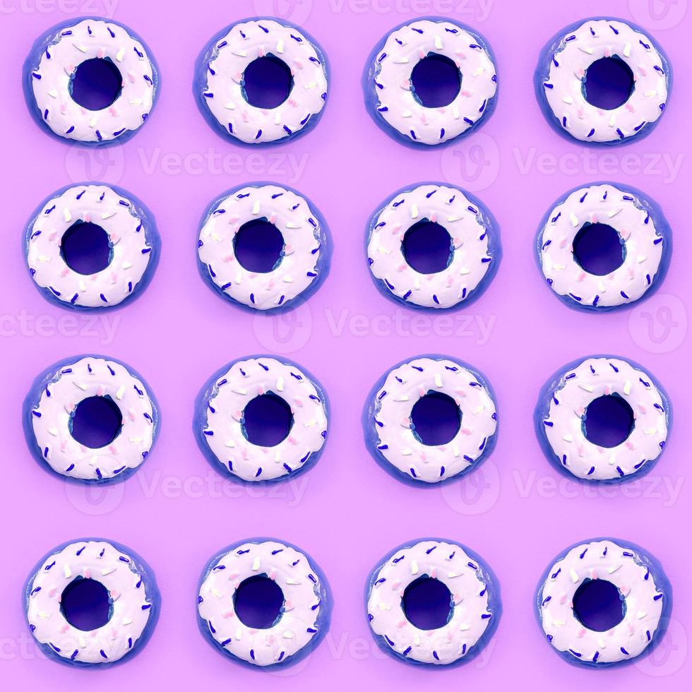 Many small plastic donuts lies on a pastel colorful background. Flat lay minimal pattern. Top view photo