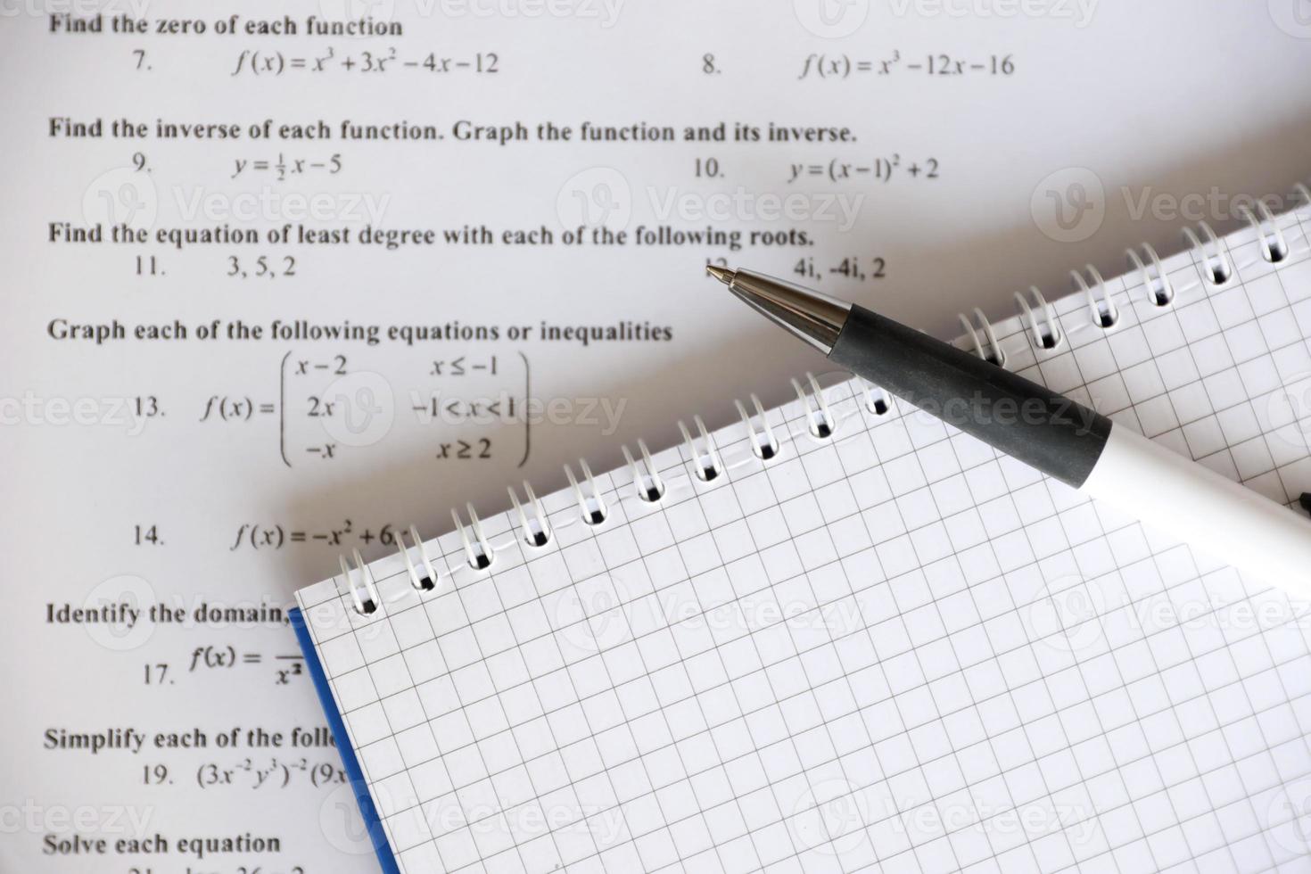 Handwriting of mathematics quadratic equation on examination, practice, quiz or test in maths class. Solving exponential equations concept. photo