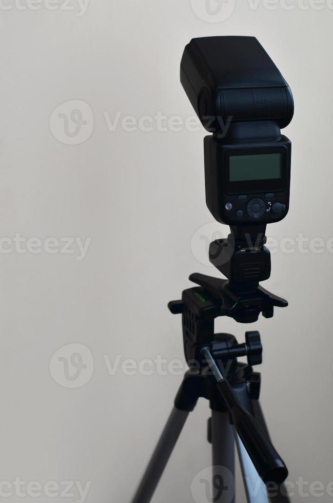 Speedlight gun with trigger set mounted on tripod photo