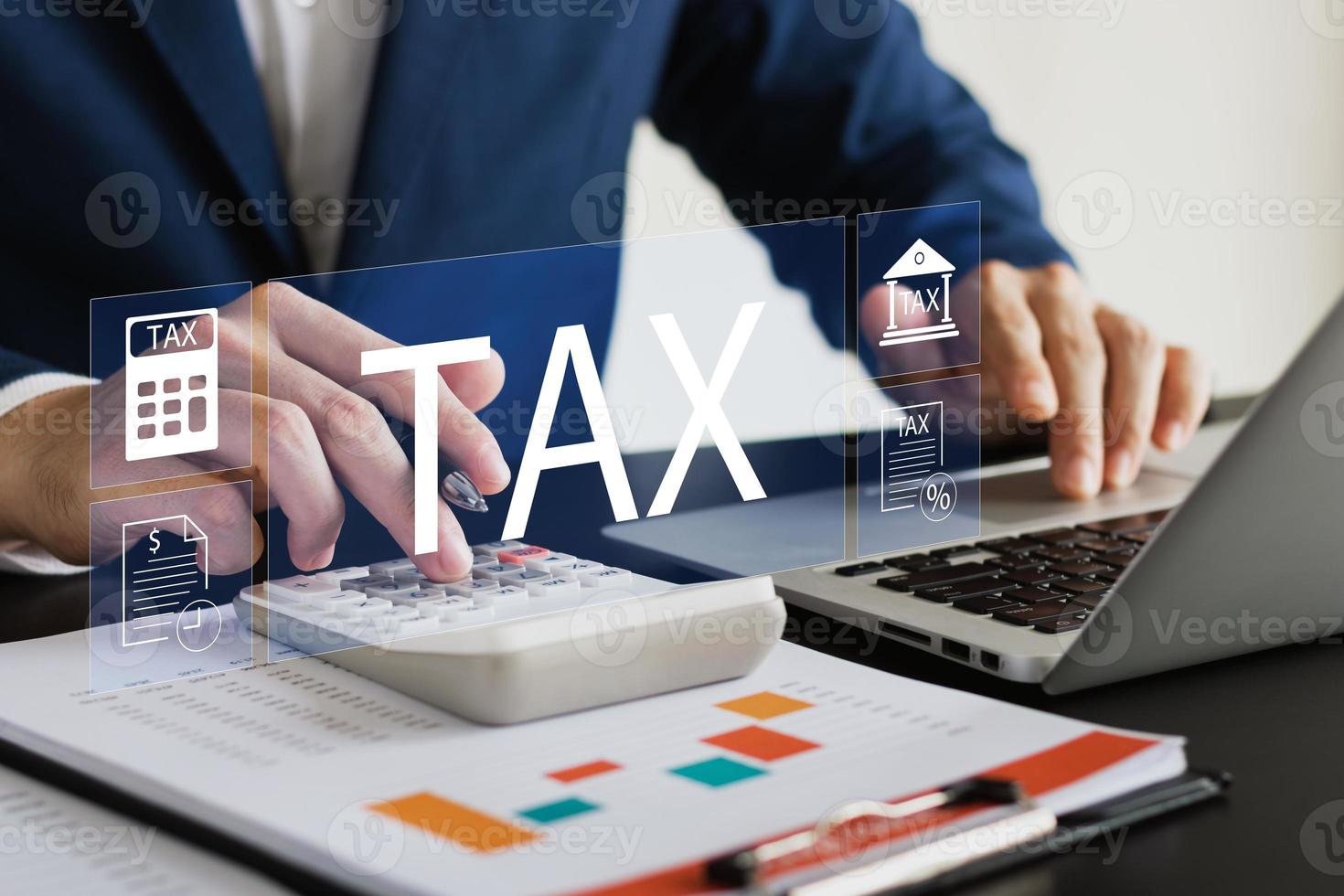 Businessman using his laptop computer to fill out online personal income tax return form for tax payment, personal income tax calculation. photo