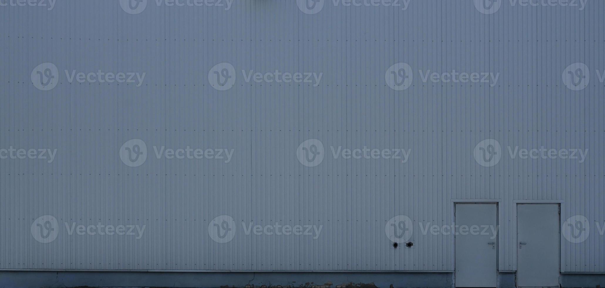 Texture of a high metal wall of an industrial building without windows photo