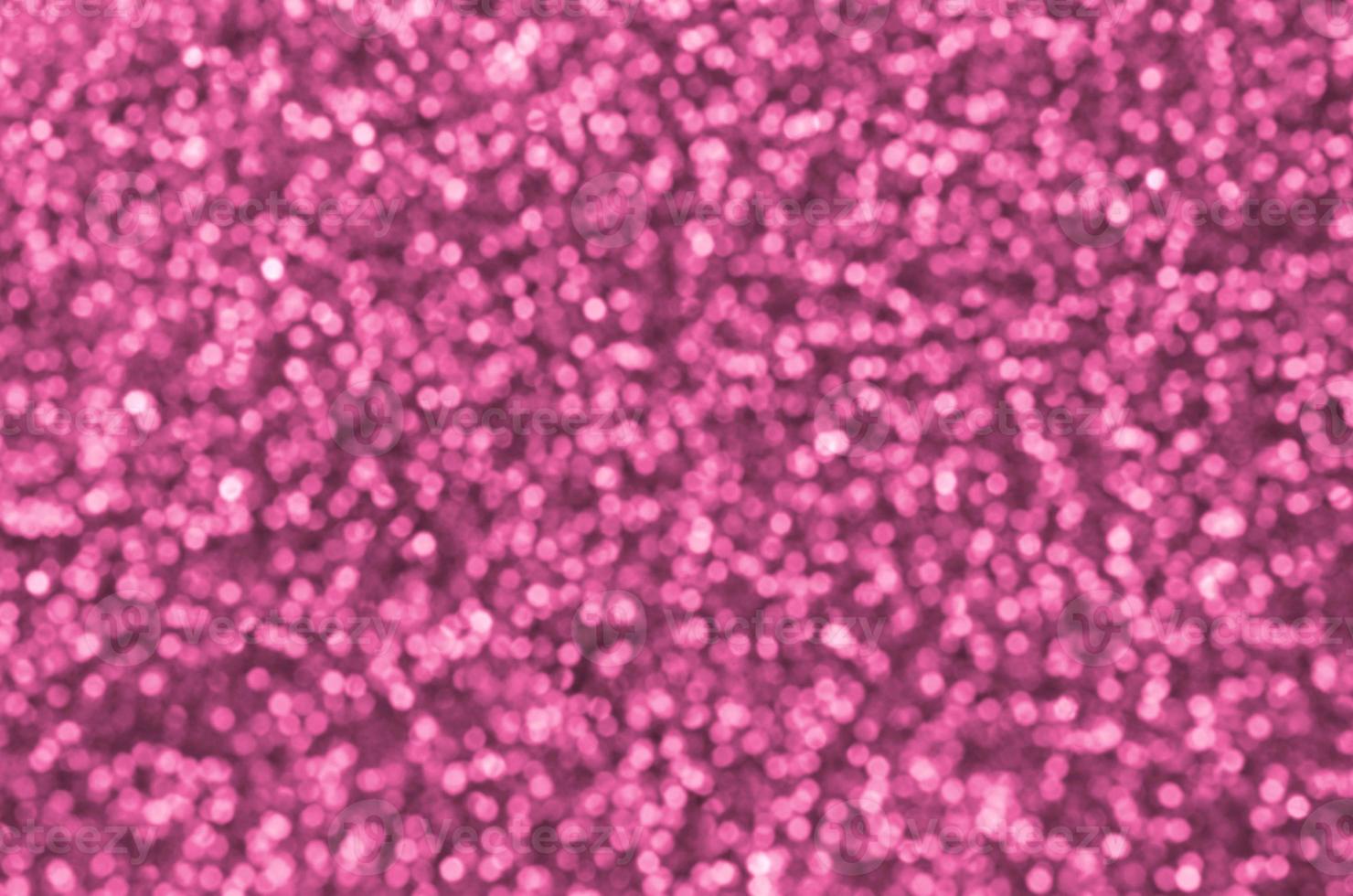 Blurred coral red decorative sequins. Background image with shiny bokeh lights from small elements photo