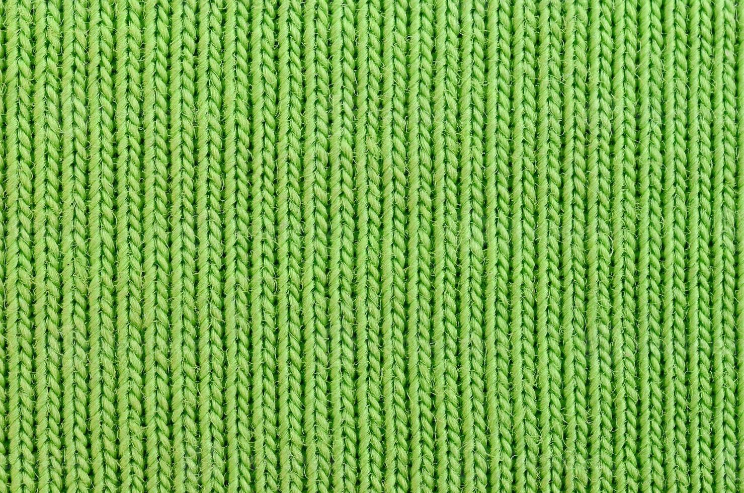 The texture of the fabric is bright green. Material for making shirts and blouses photo