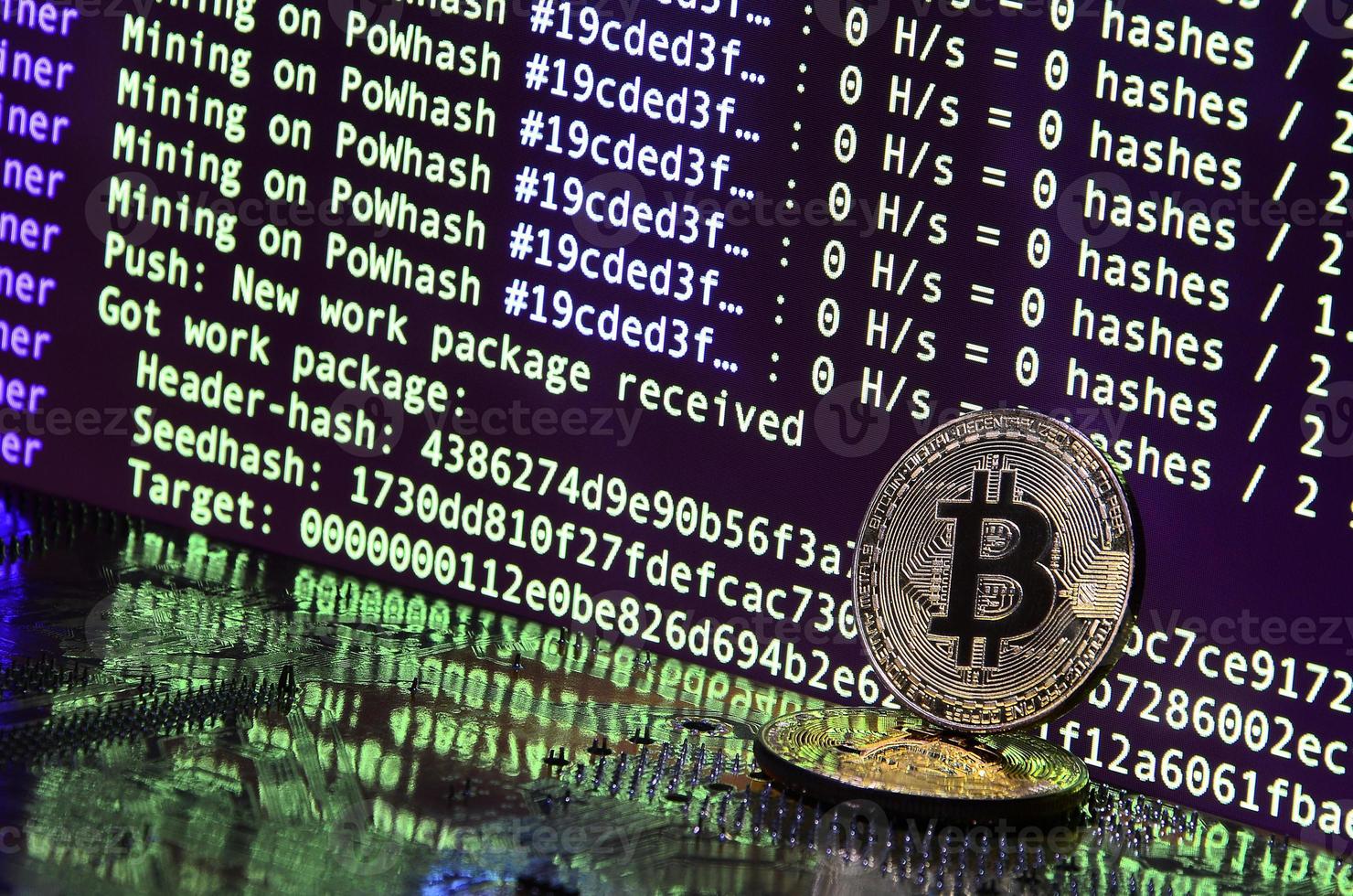 The digital process of cryptocurrency mining by using the GPUs. Bitcoins and video card on a working display and mining screen photo