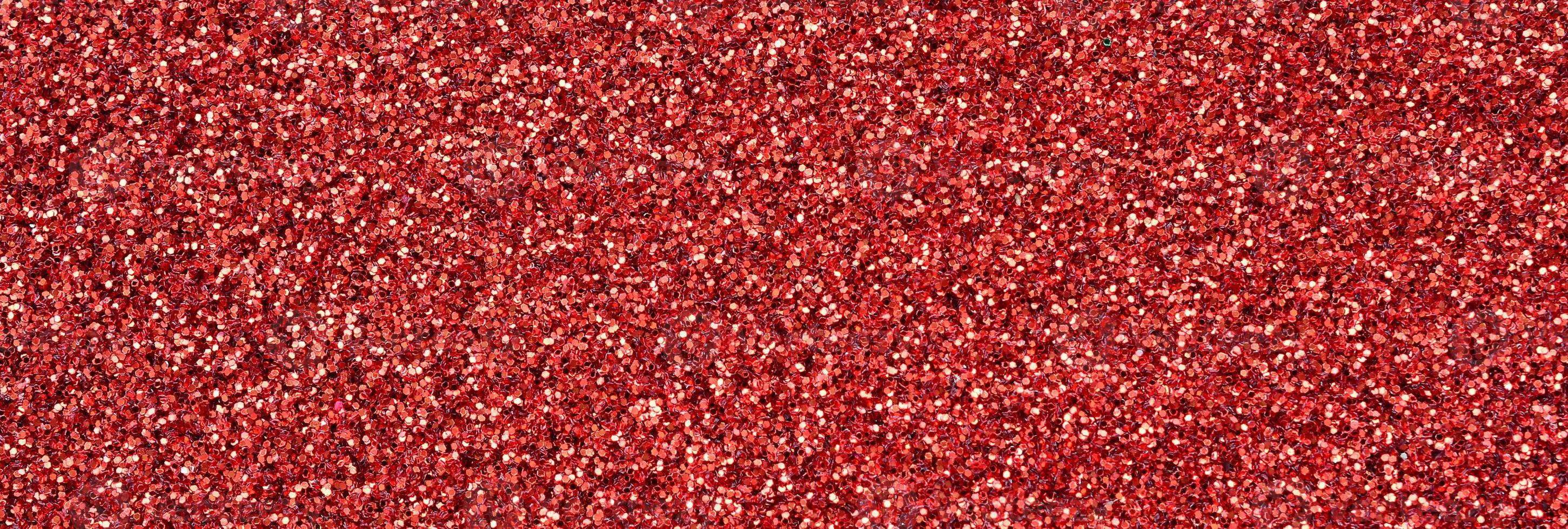 Crimson red decorative sequins. Background image with shiny bokeh lights from small elements photo