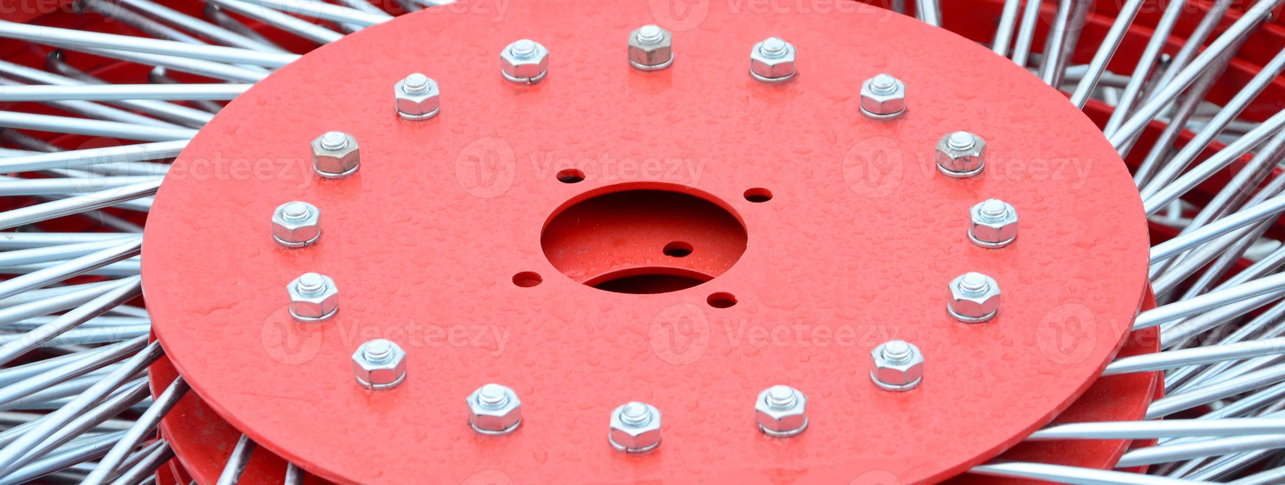New red tedder for trailer in agricultural machinery for gathering hay. Close up photo