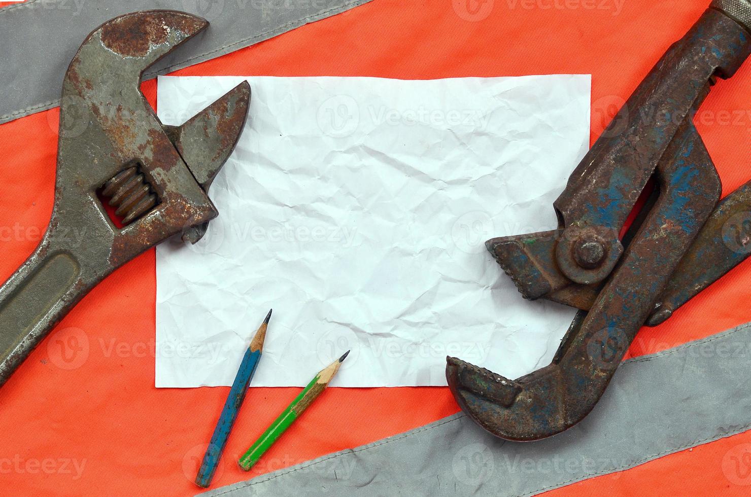 Adjustable wrenches and a sheet of paper with two pencils photo