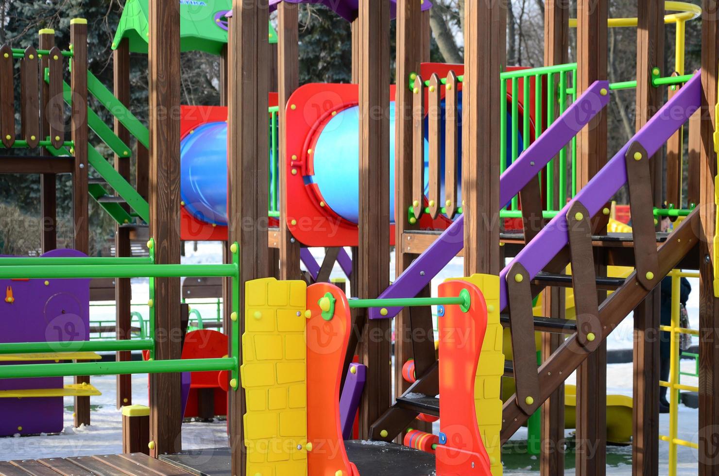 Fragment of a playground made of plastic and wood, painted in different colors photo