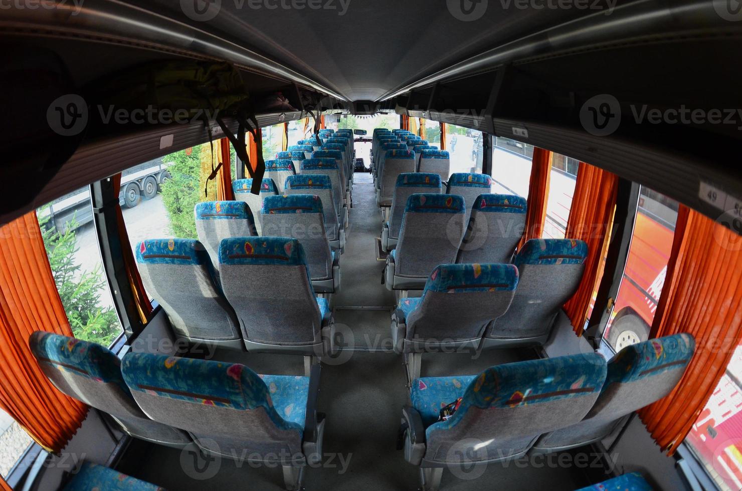 Interior of the tourist bus for excursions and long trips. A lot of free seats and places for small luggage photo