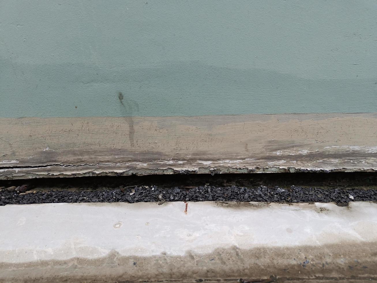 front view Cracked old concrete building broken wall at the outside line cement below. effect with earthquake photo