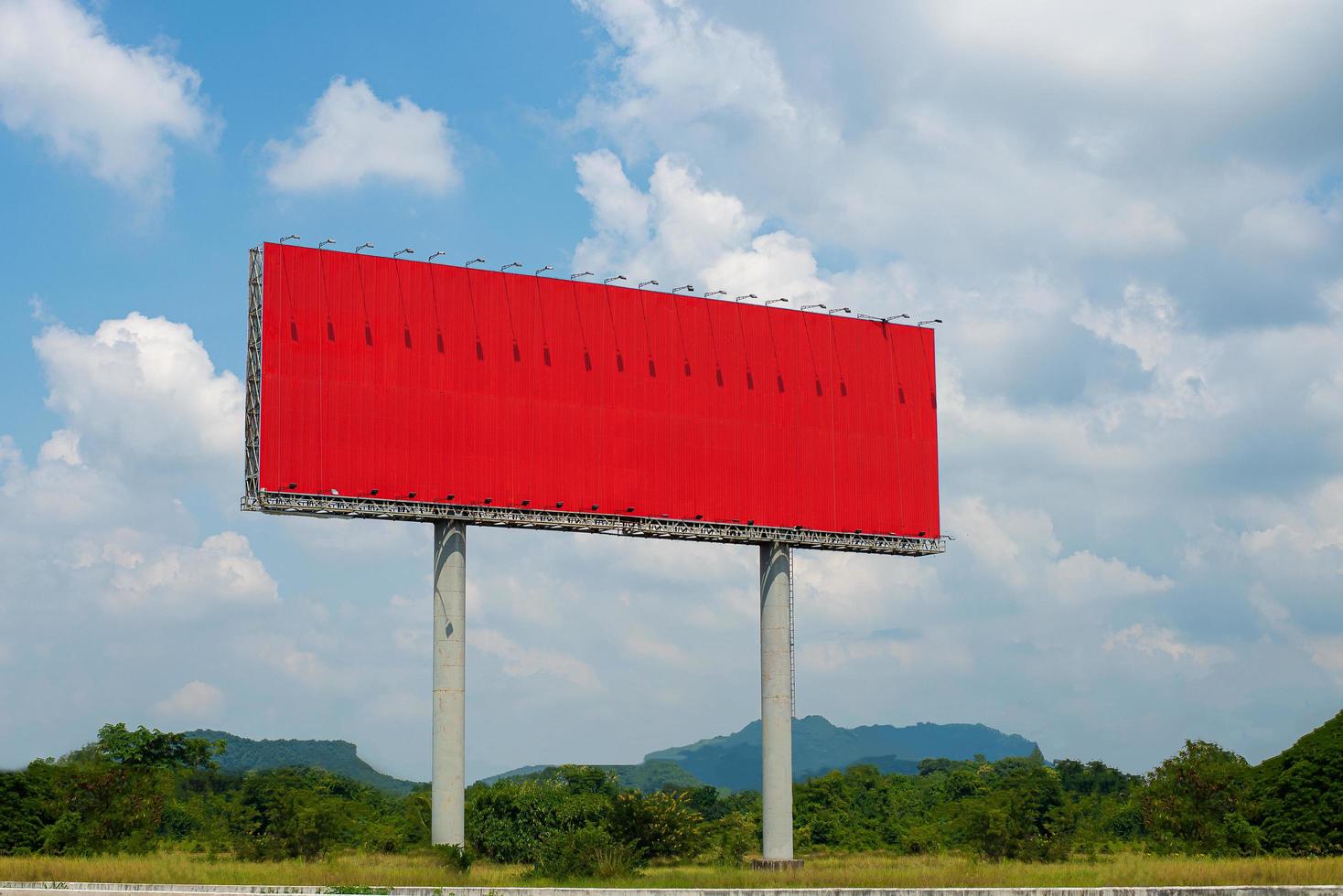 Red billboard blank with blue sky for outdoor advertising poster photo