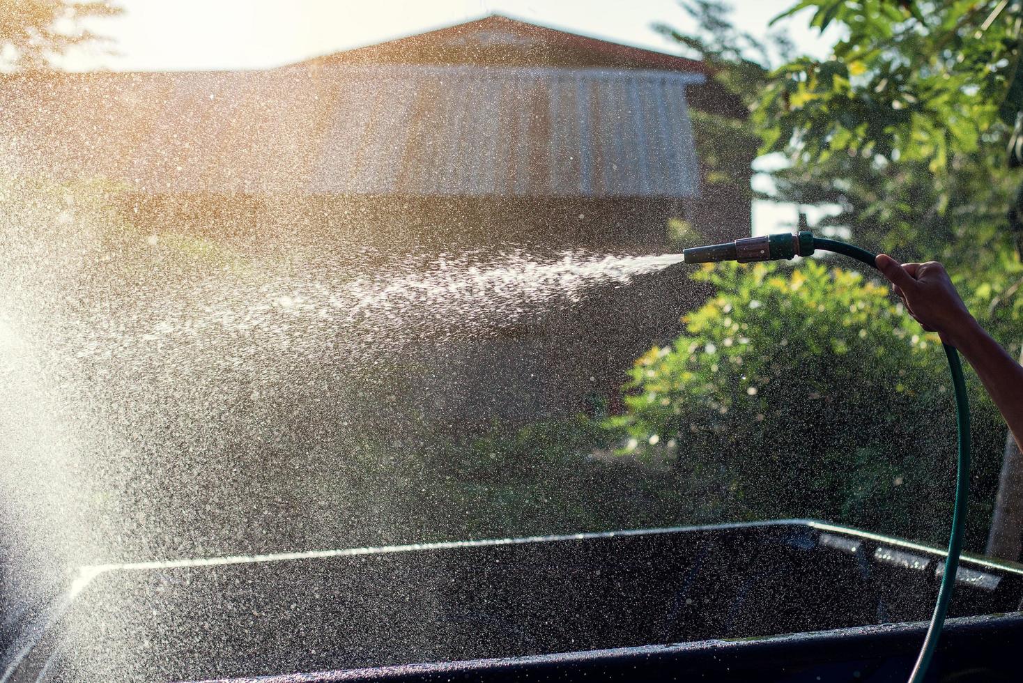 Hand holding car wash hose photo