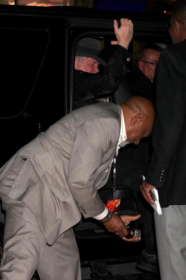 LOS ANGELES, JAN 23 - Nick Nolte, with Oscar Williams picking up beer bottle that fell out of car when door was opened arrives at the Luck Los Angeles Premiere of HBO Series at Graumans Chinese Theater on January 23, 2012 in Los Angeles, CA photo