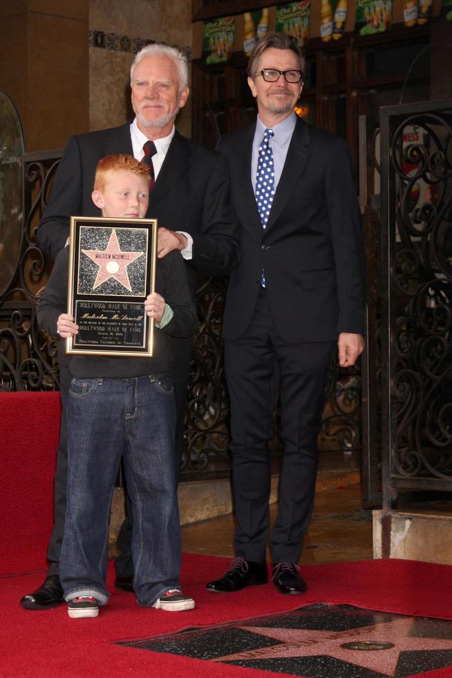 LOS ANGELES, MAR 16 - Malcolm McDowell, son Beckett McDowell, Gary Oldman at the Malcolm McDowell Walk of Fame Star Ceremony for The Muppets at the Hollywood Boulevard on March 16, 2012 in Los Angeles, CA photo