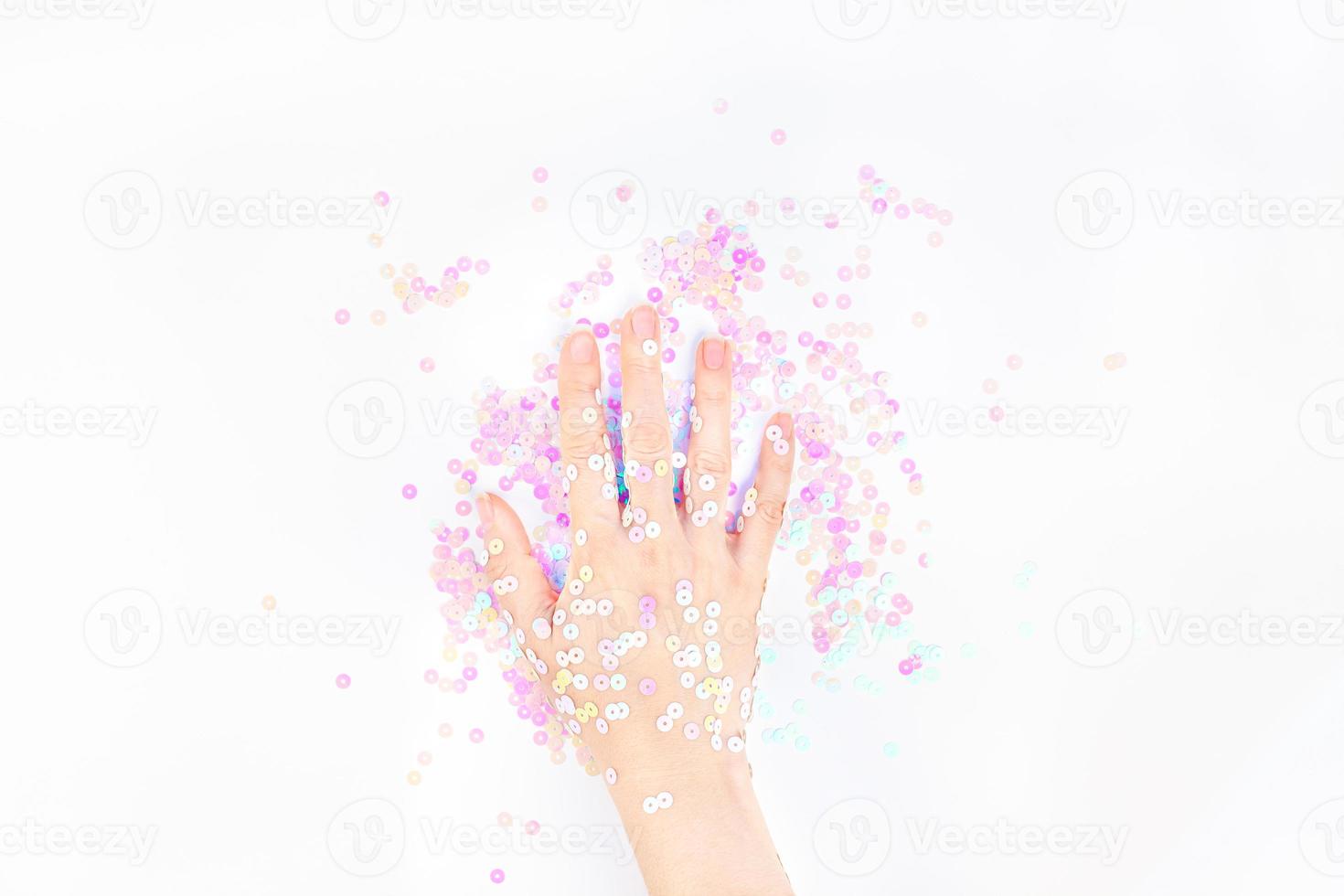 Pearl pastel confetti sparkles with woman hand photo