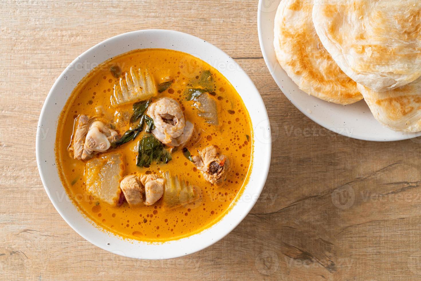 Chicken curry soup with roti photo