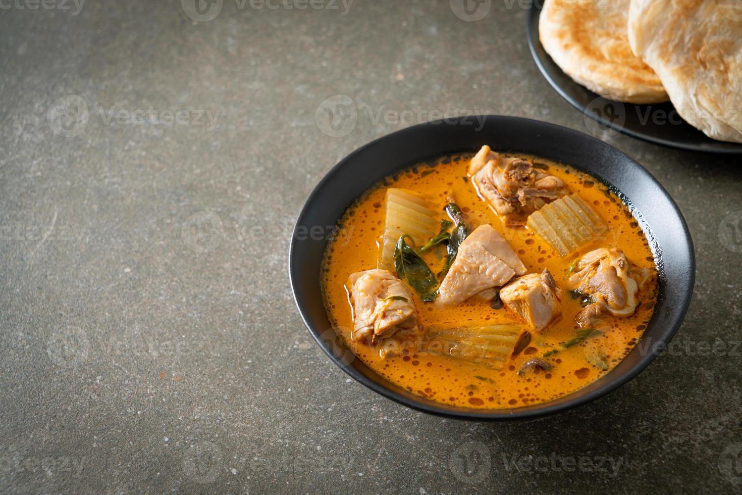 Chicken curry soup with roti photo