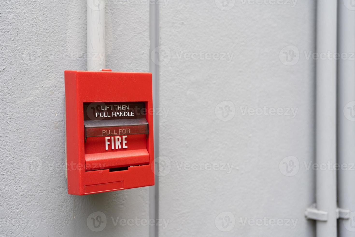 Fire alarm switch on the wall. Fire alarm switch on the factory wall. photo