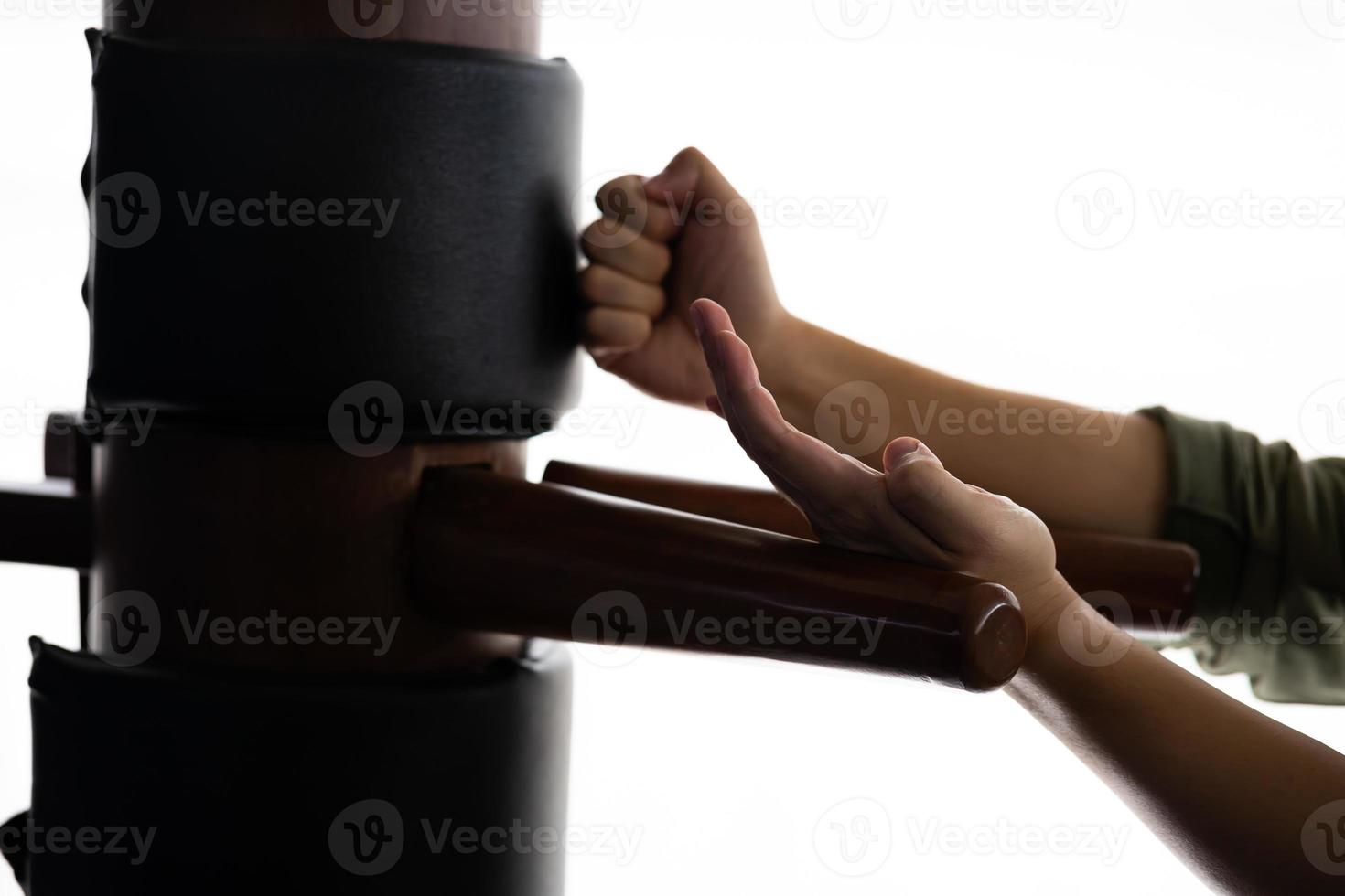 Silhouette of a fighter Wing Chun and wooden dummy on a background. Wing Chun Kung Fu Self defense photo
