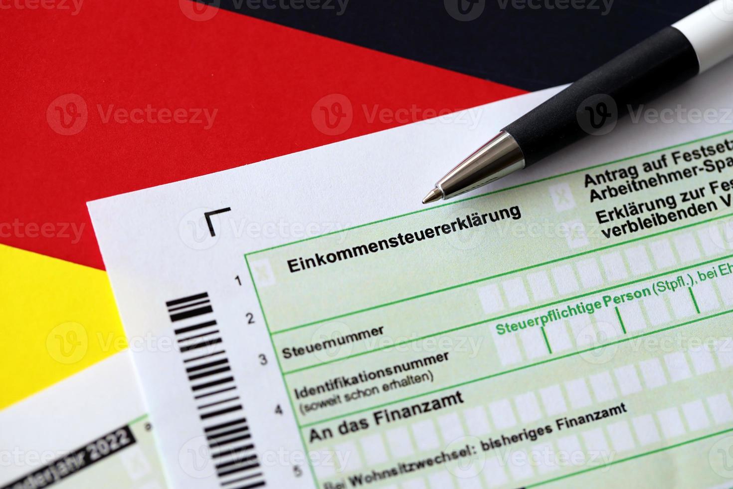 German annual tax return declaration form with pen on flag close
