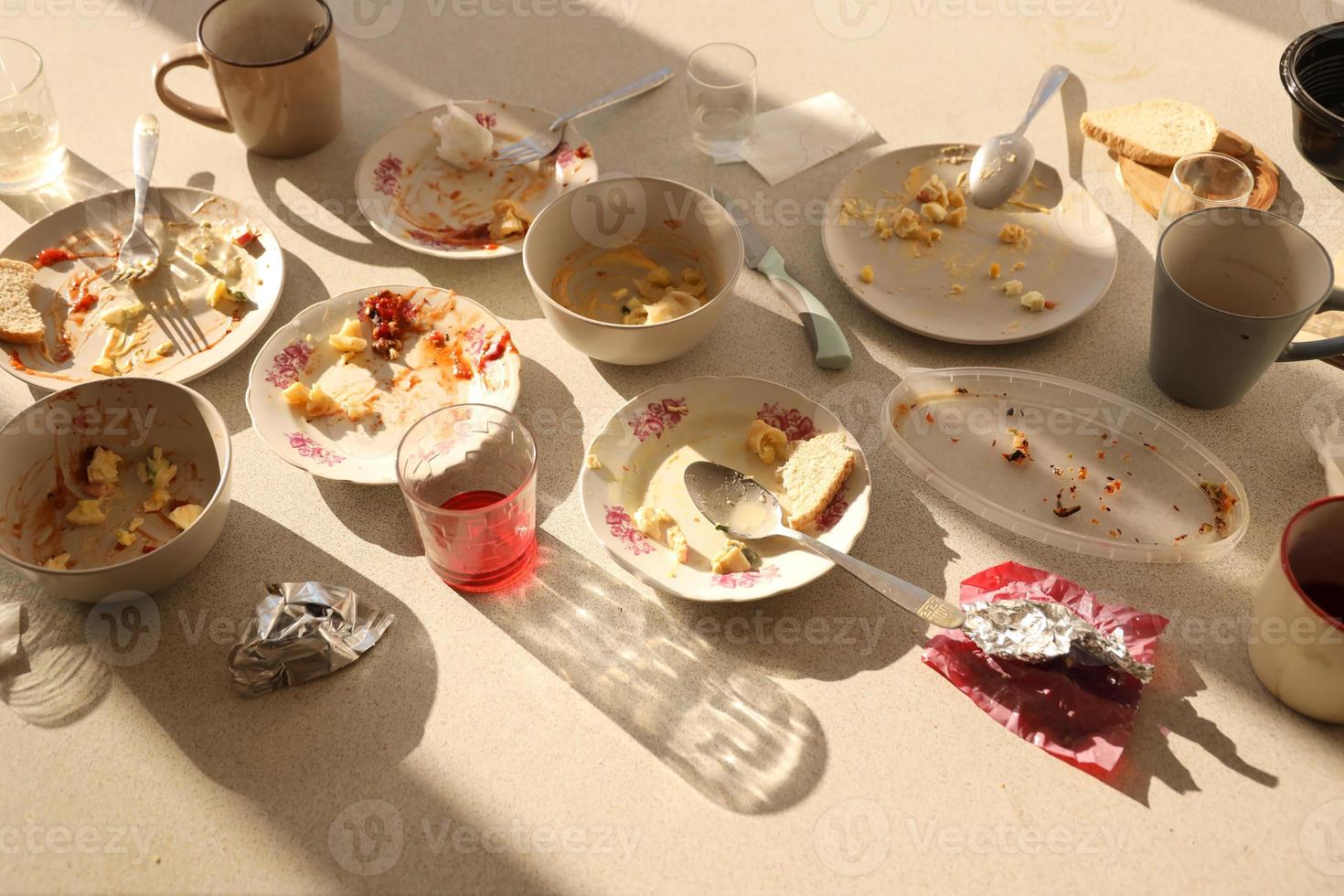 Empty dirty plates with spoons and forks on the table after meal. Banquet ending concept. Unwashed dishes photo