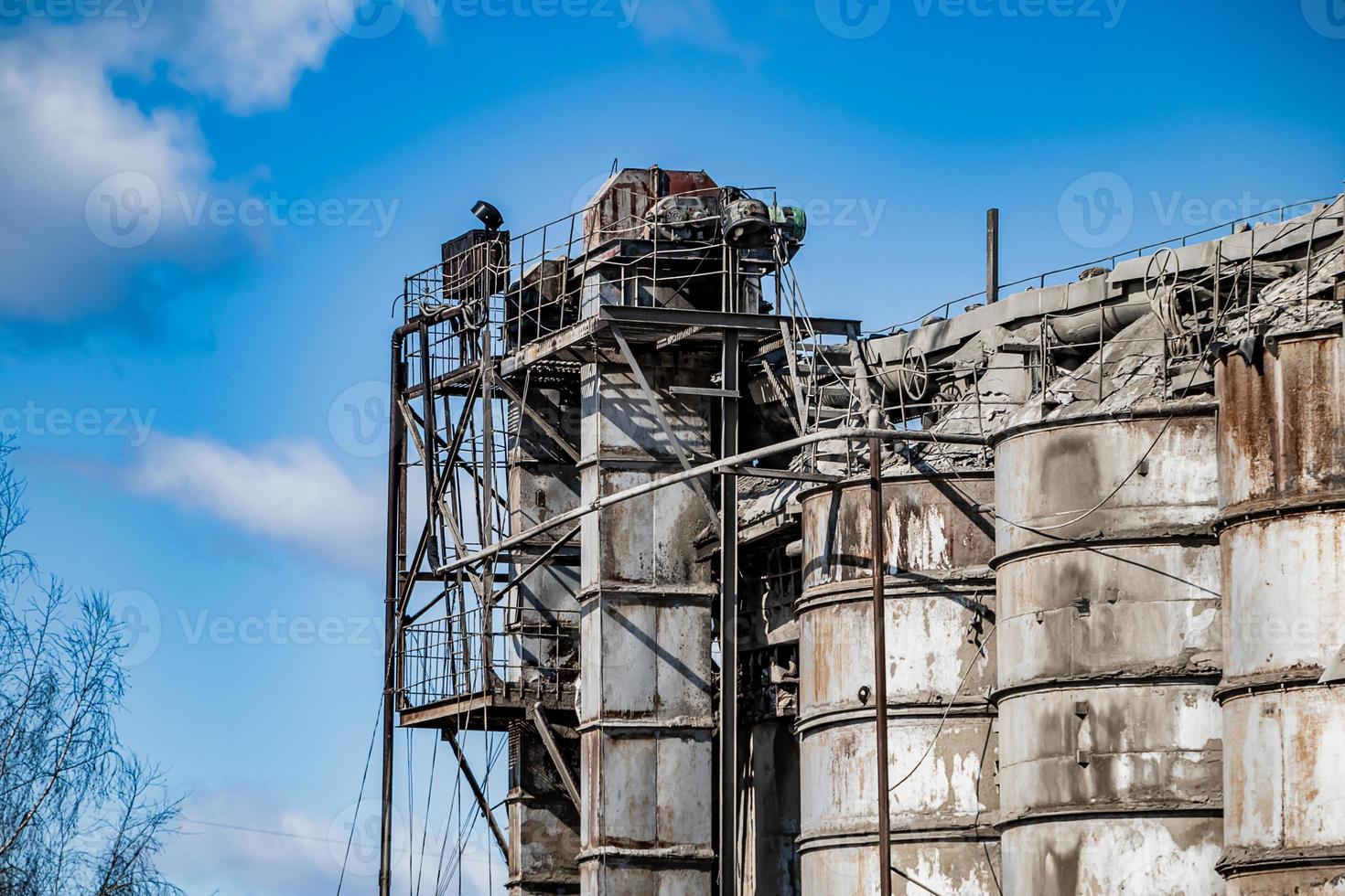 Old destroyed construction site. Rusty scaffolding and construction equipment. photo