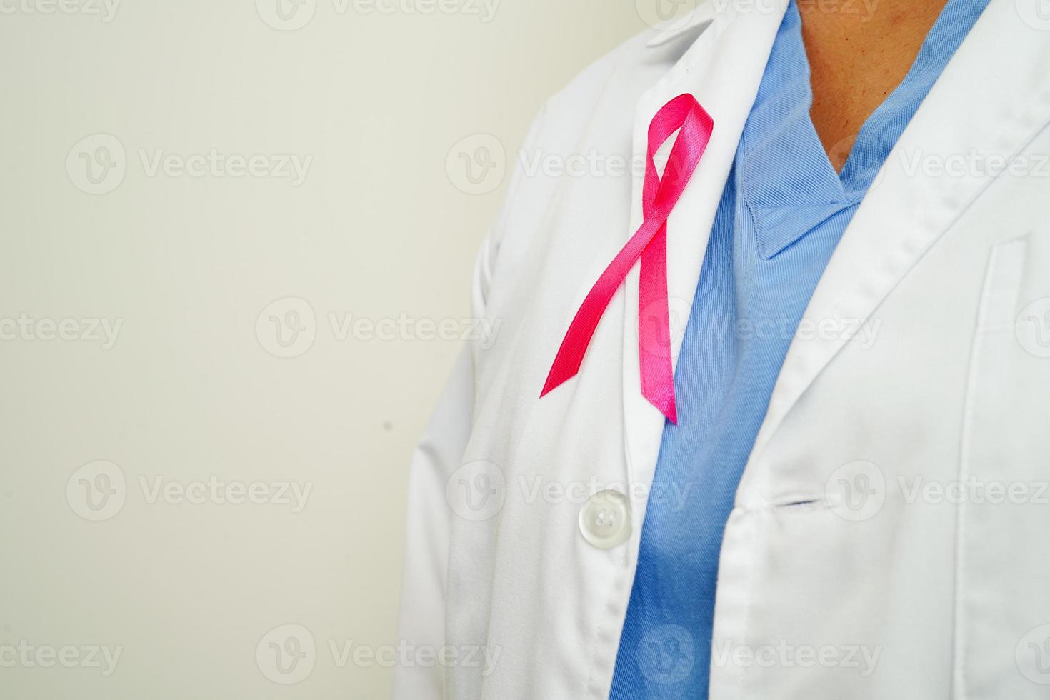 Asian woman doctor with pink ribbon, World Breast Cancer Day at October. photo